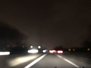 Close-up of illuminated car on road in city