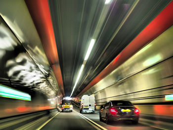 Blurred motion of cars in illuminated tunnel