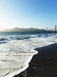 View of beach against clear blue sky