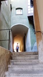 Man standing on staircase of building