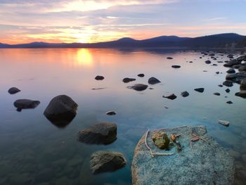 Scenic view of lake against sky during sunset