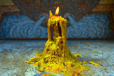 Candle with melting wax in the church . place for praying