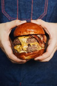 Close-up of hand holding burger