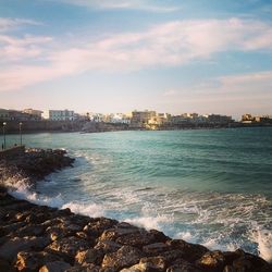 View of sea with buildings in background