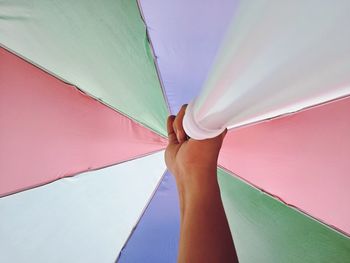 Cropped hand holding colorful umbrella