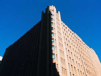 Low angle view of building against clear blue sky