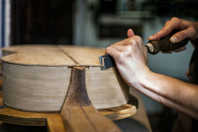 Close-up of hands working on wood