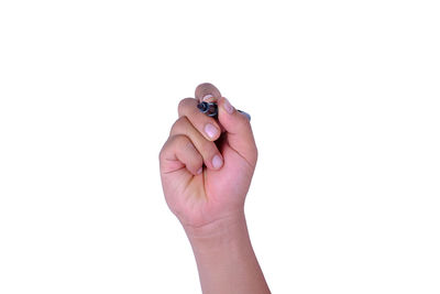 Cropped image of hand holding paper over white background