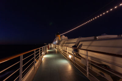 Illuminated bridge against sky at night