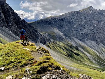 Rear view of man walking on mountain