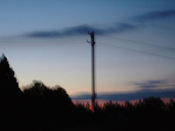 Silhouette electricity pylon against sky during sunset