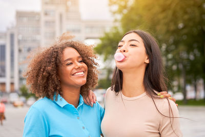 Portrait of smiling young woman in city