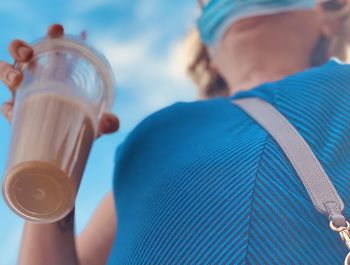 Close-up of woman holding blue drink