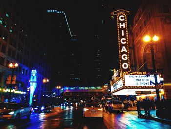 Illuminated city street and buildings at night