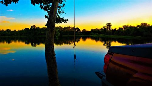 Scenic view of lake against sky during sunset