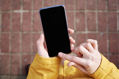 Midsection of person using mobile phone