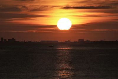 Scenic view of sea against romantic sky at sunset