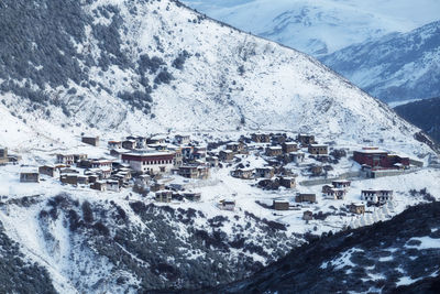 Aerial view of buildings and snowcapped mountains