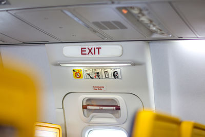 Close-up of exit sign in airplane