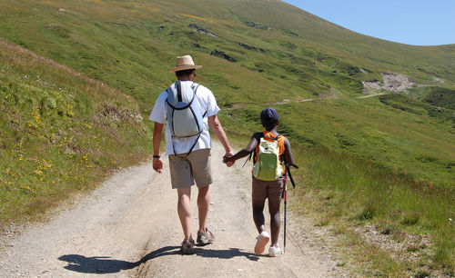 Full length of father and son walking on mountain road