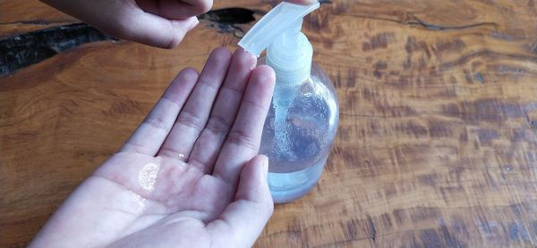 High angle view of woman hand on table