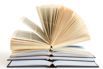 Close-up of open book against white background