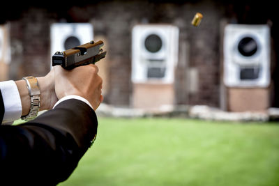 Midsection of man holding camera at home