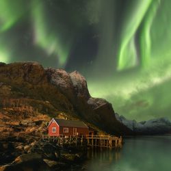 Scenic view of lake against sky at night