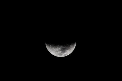 Low angle view of moon against dark sky