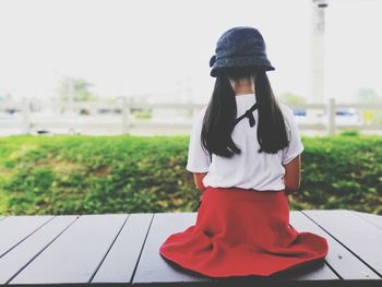 Rear view of woman standing on footpath
