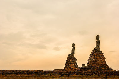 Buddha statue on sunset sky background