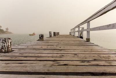 Pier over sea against clear sky