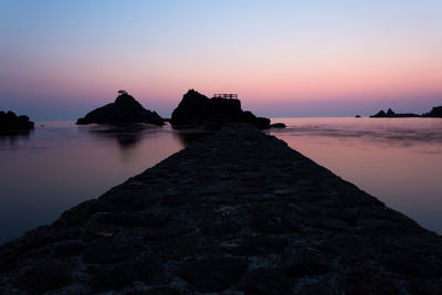 Scenic view of sea against clear sky during sunset