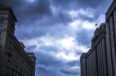 Low angle view of building against cloudy sky