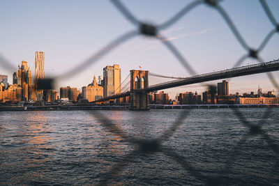 Bridge over river with buildings in background