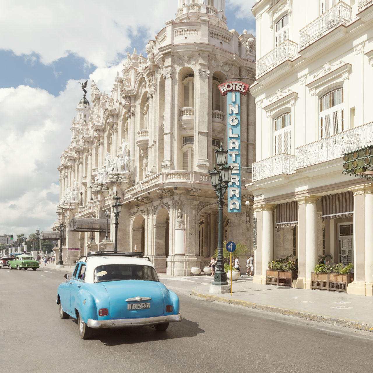 CARS ON ROAD BY BUILDINGS AGAINST SKY