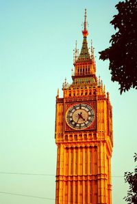 High section of clock tower against clear sky