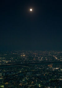 Illuminated cityscape against sky at night