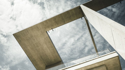 Low angle view of building against cloudy sky