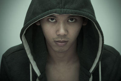 Close-up portrait of mid adult man against gray background