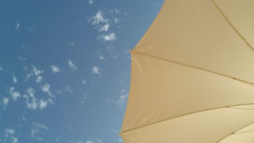 Low angle view of parasol against sky