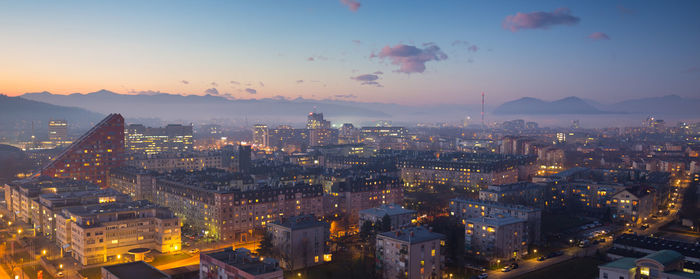 High angle view of illuminated city buildings during sunset