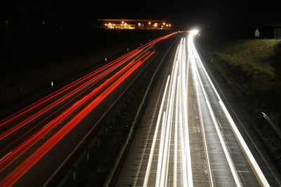 High angle view of light trails on road at night