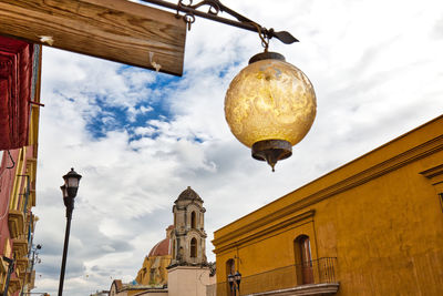 Low angle view of street and buildings against sky