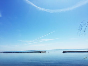 Scenic view of sea against blue sky