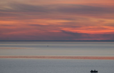 Scenic view of sea against orange sky