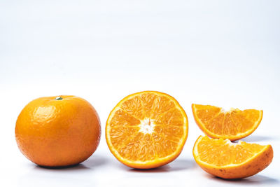Close-up of oranges against white background