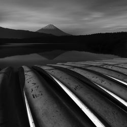 Boats and mount fuji on a peaceful night from lake saiko, yamanashi prefecture, japan