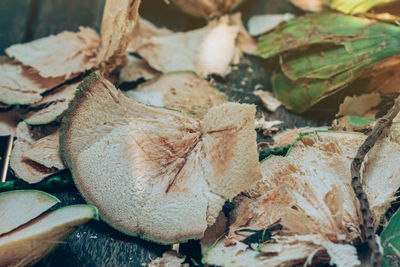 Close-up of dried autumn leaves on field