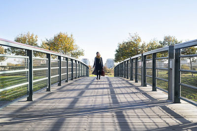 Woman at footbridge